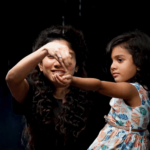 A Woman Holds A Little Girl 'S Hand And They Are Smiling GIF