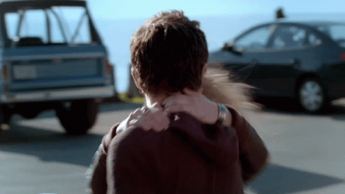 Woman Holds Man's Neck In Front Of Car GIF