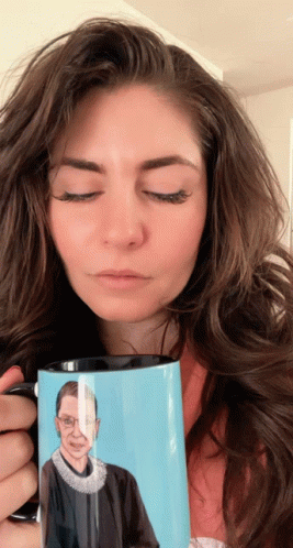 A Woman Holds A Mug With A Picture Of Ruth Bader Ginsburg GIF