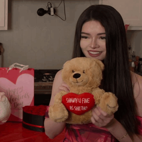 A Woman Holds A Teddy Bear With A Heart That Says Shawty U Fine Is Shit Tho GIF