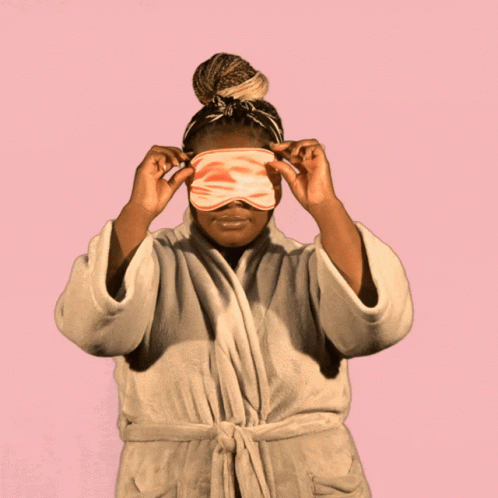 A Woman In A Bathrobe With A Sleep Mask On Her Head Says Good Morning GIF