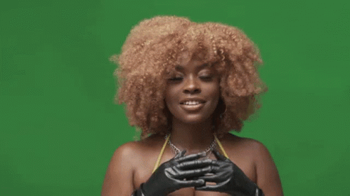 A Woman In A Bikini And Black Gloves Is Making A Funny Face . GIF