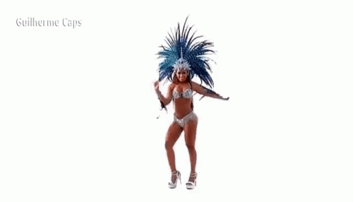 a woman in a bikini is dancing in a carnival costume with feathers .