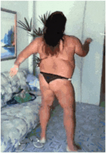 A Woman In A Bikini Is Dancing In A Living Room GIF