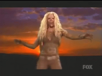 A Woman In A Bikini Is Dancing In Front Of A Fox Sign GIF