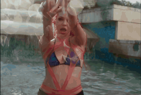 a woman in a bikini is in the water