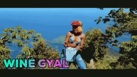 A Woman In A Bikini Is Standing In A Field With The Words Wine Gyal On The Bottom GIF