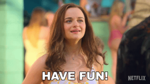 A Woman In A Bikini Says " Have Fun " In A Netflix Ad GIF