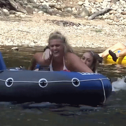 A Woman In A Bikini Sits On A Blue Raft With The Letter O On The Side GIF