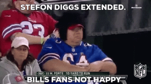 A Woman In A Bills Jersey Is Sitting In The Stands Watching A Football Game GIF