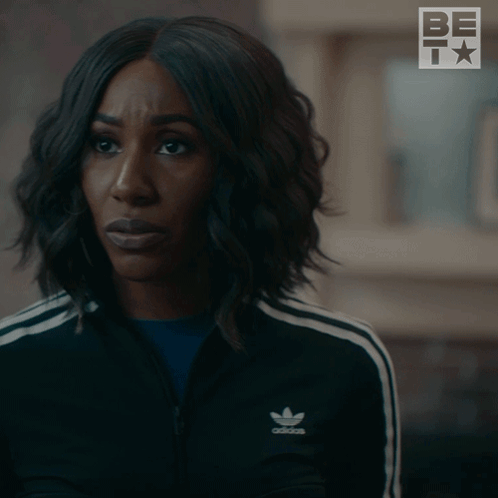 A Woman In A Black Adidas Jacket Is Asking Really GIF