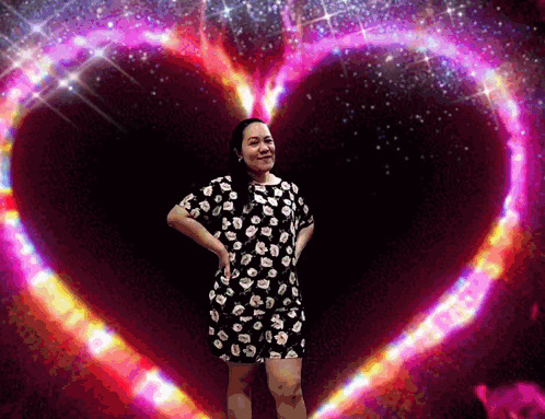 Woman In Floral Dress In Front Of Pink Heart GIF
