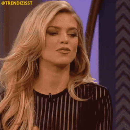 A Woman In A Black And White Striped Shirt Is Clapping Her Hands .. GIF