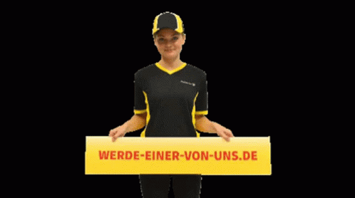 A Woman In A Black And Yellow Shirt Holds A Yellow Sign That Says Werde-Einer-Von-Uns.de GIF