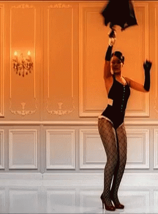 A Woman In A Black Bodysuit Is Dancing In A Room While Holding An Umbrella Over Her Head . GIF