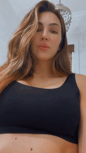 Woman In Black Bra Looking Down GIF
