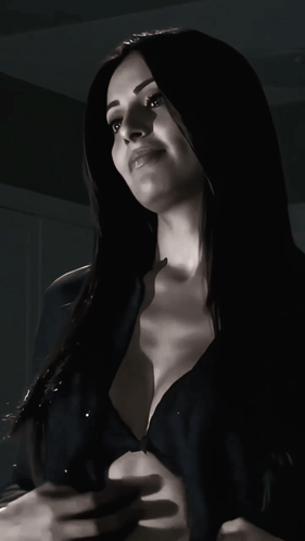 A Woman In A Black Bra Looks Up At The Sky GIF