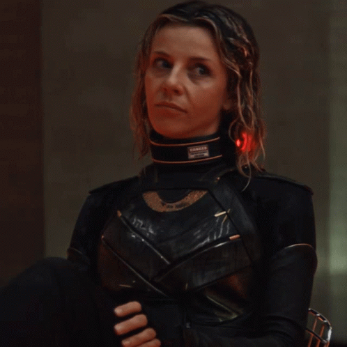 A Woman In A Black Costume Has A Collar That Says ' Danger ' On It GIF