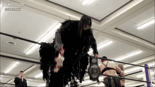A Woman In A Black Costume Is In A Wrestling Ring Sponsored By Stardom GIF