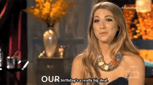 A Woman In A Black Dress And Necklace Is Talking About Her Birthday Being A Really Big Deal . GIF