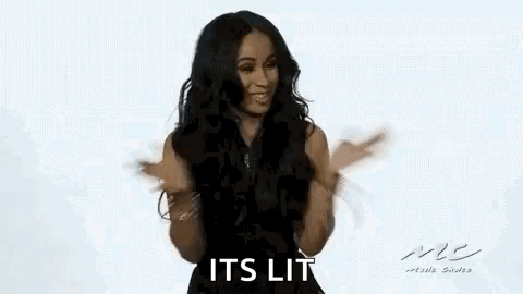 A Woman In A Black Dress Is Dancing With Her Arms Outstretched And Smiling . GIF