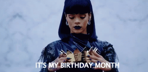 A Woman In A Black Dress Is Holding A Crown In Her Hands And Saying `` It 'S My Birthday Month '' . GIF