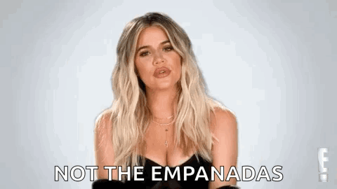 A Woman In A Black Dress Is Making A Funny Face And Says `` Not The Empanadas '' . GIF