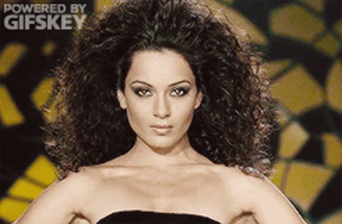 A Woman In A Black Dress Is Powered By Gifskey GIF