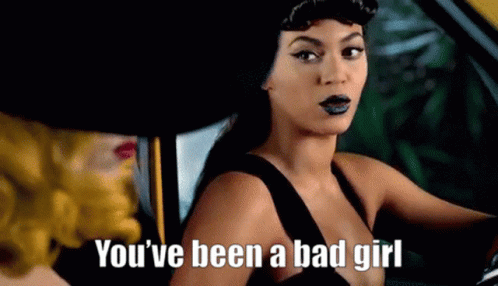 A Woman In A Black Dress Is Sitting In A Car With A Woman In A Yellow Hat . GIF