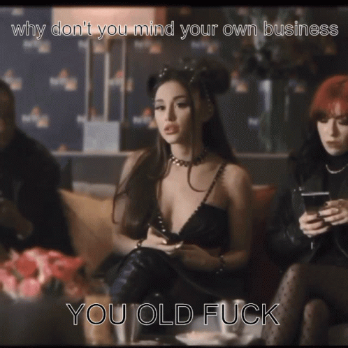 A Woman In A Black Dress Is Sitting On A Couch With The Caption " Why Don T You Mind Your Own Business You Old Fuck GIF