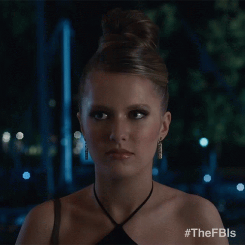 A Woman In A Black Dress Is Smiling And Has The Hashtag #Thefbls On Her Shoulder GIF