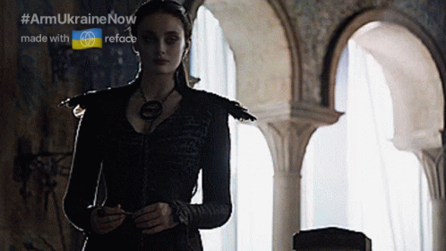 A Woman In A Black Dress Is Standing In A Room With Arches And The Words Armukrainenow Made With Reface GIF