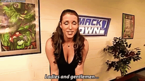 A Woman In A Black Dress Is Standing In Front Of A Wall With A Sign That Says `` Ladies And Gentlemen '' . GIF