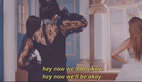 A Woman In A Black Dress Is Standing Next To Another Woman In A White Dress In Front Of A Mirror . GIF