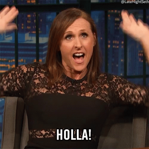 A Woman In A Black Dress Says Holla With Her Mouth Open GIF