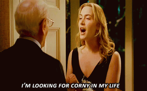 A Woman In A Black Dress Says I 'M Looking For Corny In My Life To A Man In A Suit GIF