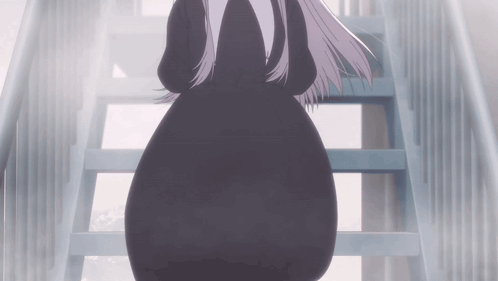 A Woman In A Black Dress Walking Down Stairs GIF