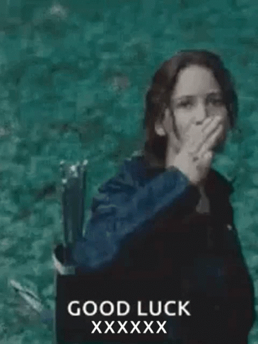 A Woman In A Black Jacket Is Giving The Middle Finger In Front Of The Ocean . GIF