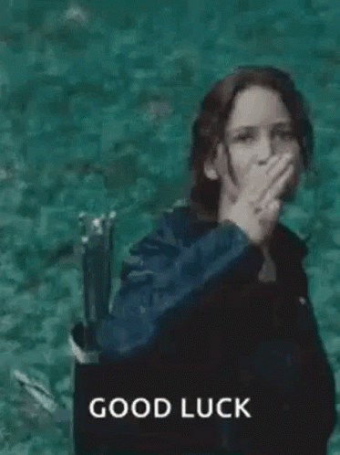 A Woman In A Black Jacket Is Giving The Middle Finger While Standing In The Water . GIF