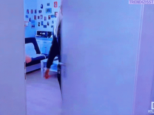 Woman In Black Jacket Standing In Doorway GIF
