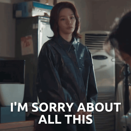 A Woman In A Black Jacket Says I 'M Sorry About All This In White Letters GIF