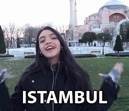 A Woman In A Black Jacket With The Word Istanbul On Her Jacket GIF
