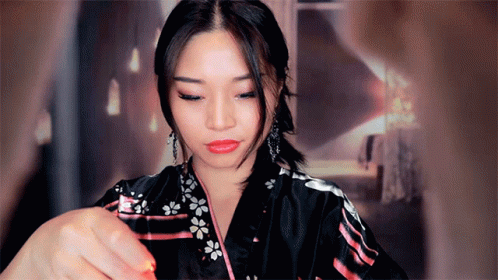 A Woman In A Black Kimono With Flowers On It GIF