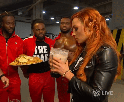 A Woman In A Black Leather Jacket Is Holding A Glass Of Milk And A Tray Of Pancakes GIF