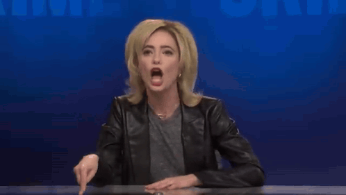 A Woman In A Black Leather Jacket Is Making A Funny Face GIF