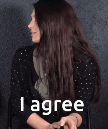 a woman in a black polka dot shirt says i agree