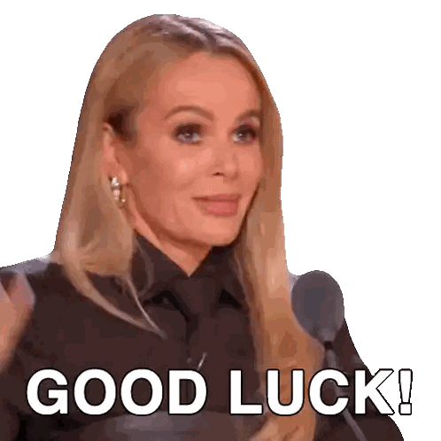 a woman in a black shirt and tie says good luck in front of a microphone