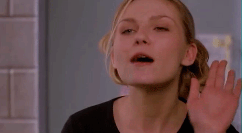 A Woman In A Black Shirt Is Making A Funny Face GIF