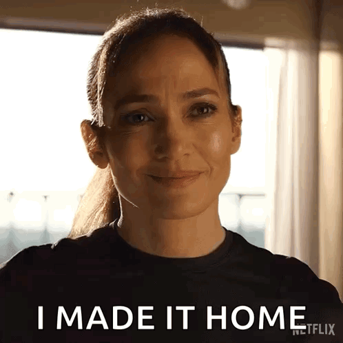 Woman In Black Shirt Smiling Saying I Made It Home GIF