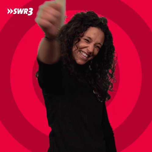 A Woman In A Black Shirt Is Smiling In Front Of A Red Circle With Swr3 Written On It GIF